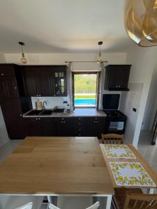 a kitchen with a wooden table and a window at Casa Fortunata in Kaštel +5 photos