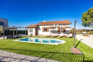 a house with a swimming pool in a yard at Casa Fortunata in Kaštel