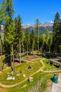 a park with a picnic area with trees and mountains at ''BalconyView'' by Staymarilleva1400 in Marilleva