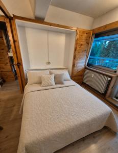a large bed in a room with a large window at ''BalconyView'' by Staymarilleva1400 in Marilleva +29 photos