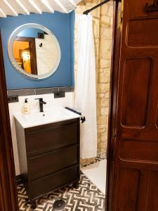a bathroom with a sink and a mirror at La Mío Quintana in Corao +11 photos