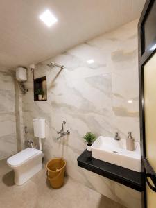 a bathroom with a sink and a toilet at Garbat valley view Matheran in Matheran