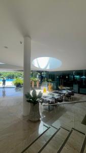 a lobby with tables and a potted plant in a building at Ocean View Corner Studio Private Balcony Tambuli Tower F in Maribago
