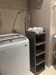 a drying rack next to a stove in a kitchen at Ocean View Corner Studio Private Balcony Tambuli Tower F in Maribago