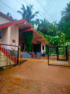 a house with a gate in front of it at Manjunatha nilaya sute delux ordinary room in Kollūru