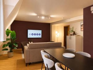 a living room with a couch and a table at Malerweg Residenz in Pirna