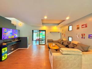 a living room with a couch and a tv at A1-Mountain View Private Pool Villa-บางแสน in Chon Buri