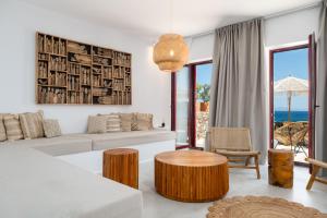 a living room with a couch and a table at Antiparos Gems - The villa in Antiparos +31 photos