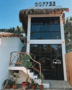a coffee shop with a sign on the door at Poddwell Siquijor in San Juan
