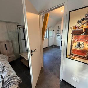 a room with a bed and a door with a poster at Charmant studio climatisé Kintzheim in Kintzheim
