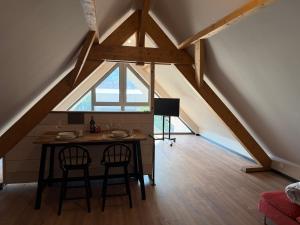 a dining room with a table and a window at Charmant studio climatisé Kintzheim in Kintzheim