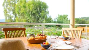 a wooden table with a bowl of fruit on it at Royal Palm in Porto-Vecchio +126 photos