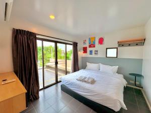 a bedroom with a bed and a large window at A1-Mountain View Private Pool Villa-บางแสน in Chon Buri +38 photos