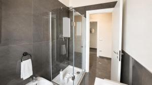 a bathroom with a shower with a toilet and a sink at Brahma luxury B&B in Marigliano