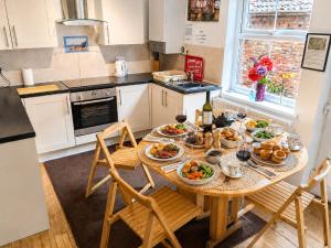a kitchen with a table with food on it at Endeavour Cottage Whitby Quiet Old Yard Fishermans Cottage in Whitby