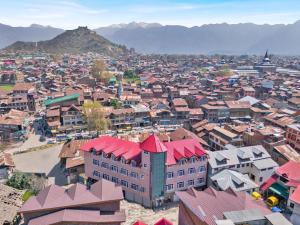 an aerial view of a city with buildings and mountains at hotel the kannaz in Srinagar