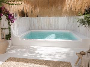 a bath tub with blue water in a room at Villa Samalas Boutique Resort & Private Pool Villas in Gili Meno
