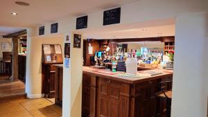 a bar in a pub with a lot of alcohol at The Fox at Ibstone in High Wycombe +12 photos