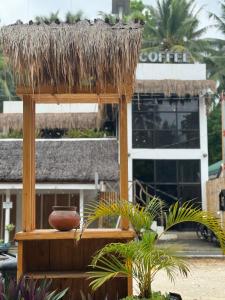 a hut with a bowl on top of it in front of a building at Poddwell Siquijor in San Juan +16 photos
