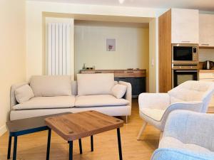 a living room with a couch and a table at L'Accalmie - Résidence calme, Plein centre, Plain pied in Crest