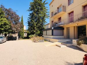 a parking lot in front of a building at L'Accalmie - Résidence calme, Plein centre, Plain pied in Crest