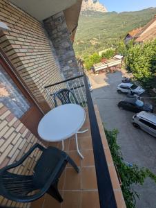 a white table and chairs on a balcony with a view at Casa Doro in Escalona