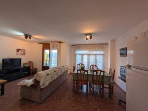 a living room with a couch and a table with chairs at Casa Doro in Escalona