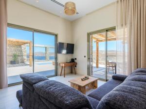 a living room with a couch and a table at Vinara Luxury Suites Mykonos in Mykonos