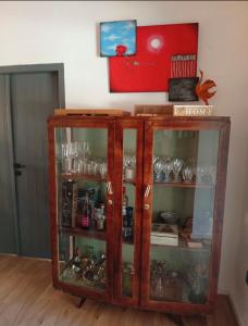 a wooden cabinet with glass doors in a room at Little paradise in Limassol +14 photos