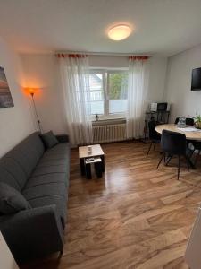 a living room with a couch and a table at Apartment Bielefeld-Brake - nähe Bahnhof -Parken im Hof in Bielefeld