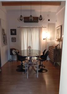 a dining room with a glass table and chairs at Little paradise in Limassol