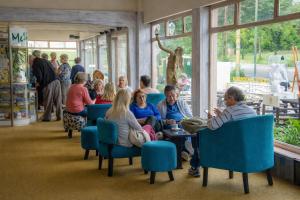 a group of people sitting in chairs in a room at Gran Hotel Nortomarza in La Falda +2 photos