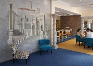 a wall mural in a restaurant with people sitting at tables at Gran Hotel Nortomarza in La Falda