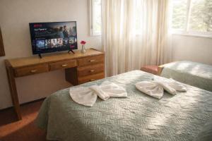 a hotel room with two white towels on a bed at Gran Hotel Nortomarza in La Falda