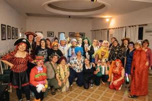 a group of people dressed in costumes posing for a picture at Gran Hotel Nortomarza in La Falda