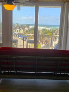 a bench in a room with a view of the ocean at The Surf Shack at Harbour Beach Resort in Daytona Beach
