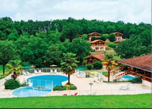 an aerial view of a resort with a swimming pool at Chalet le Chal'Heureux in Mauroux