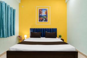 a bedroom with a large bed with a blue headboard at Rudraksh Residency in Varanasi +11 photos