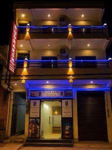 a building with blue lights on the side of it at Rudraksh Residency in Varanasi