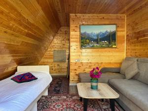 a room with a bed and a couch and a table at Bayaman Guest House in Bokonbayevo