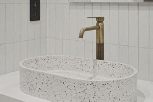 a sink in a bathroom with a faucet at The Retro Suite Kato Paphos 2 min to the beach in Paphos +33 photos