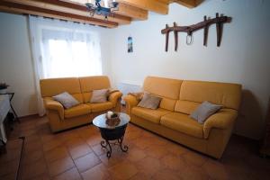 a living room with two couches and a table at Casa Rural La Celestina in Navalmoro