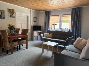 a living room with a couch and a table at Ferienwohnung im Ort in Röbel