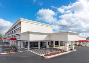 a large white building with a parking lot at Boutique Hotel in Texarkana
