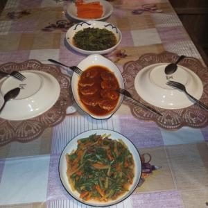 a table with plates of food on a table at KAINORA Guest Hause in Pulau Batanta