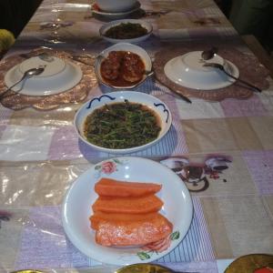 a table with plates of food and bowls of food at KAINORA Guest Hause in Pulau Batanta