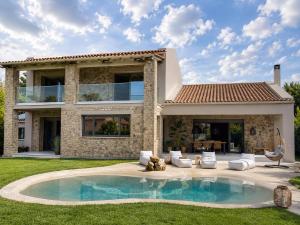 a house with a swimming pool in the yard at Villa Tartaya Boutique Villa with Private Pool in Corfu in Dassia