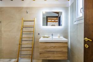 a bathroom with a sink and a ladder and a mirror at Pyrgos Country House in Skopelos Town +43 photos