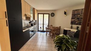 a kitchen and living room with a couch and a table at La Casina - Centro Colere - 600mt dagli impianti in Colere