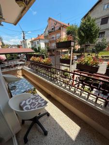 a balcony with a table and some plants on it at Apartment Gajic in Belgrade